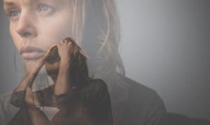 Depressed, anxious young woman suffering from mental disorders illness.