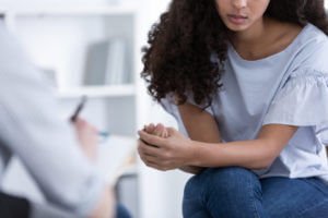 An american girl during meeting with professional spiritual counselor.