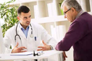 Primary care doctor explains to patient about annual health checkup.