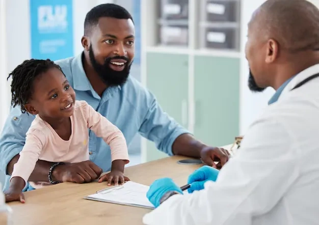 Father and daughter meeting with a pediatric provider at Abundance Health Care in Colorado Springs, CO