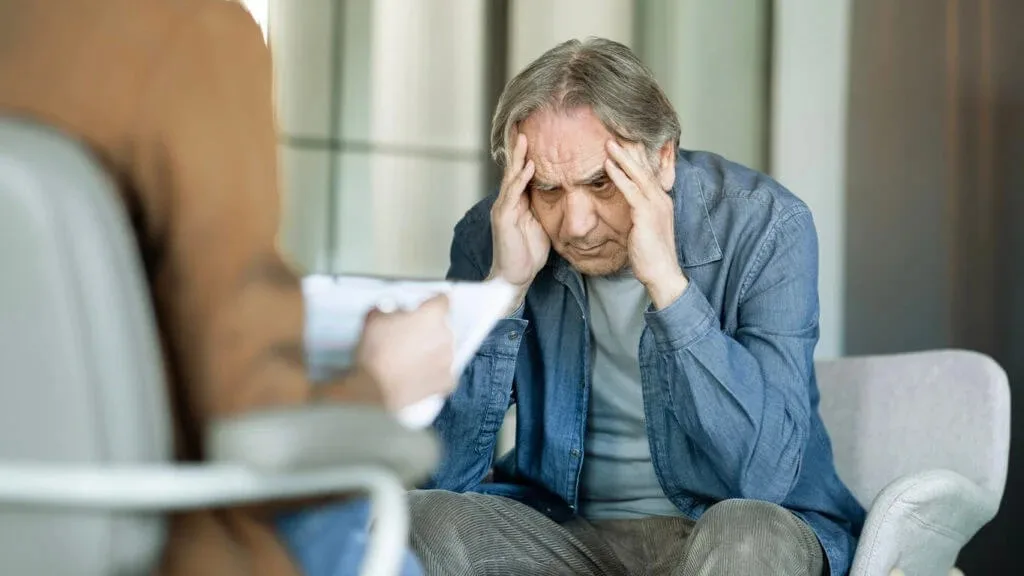 A senior patient discusses mental health concerns during a consultation with a counselor at Abundance Health Care in Colorado Springs