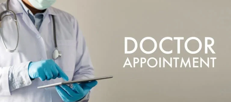 A doctor uses a tablet to schedule a checkup appointment, illustrating easy appointment scheduling at Abundance Health Care