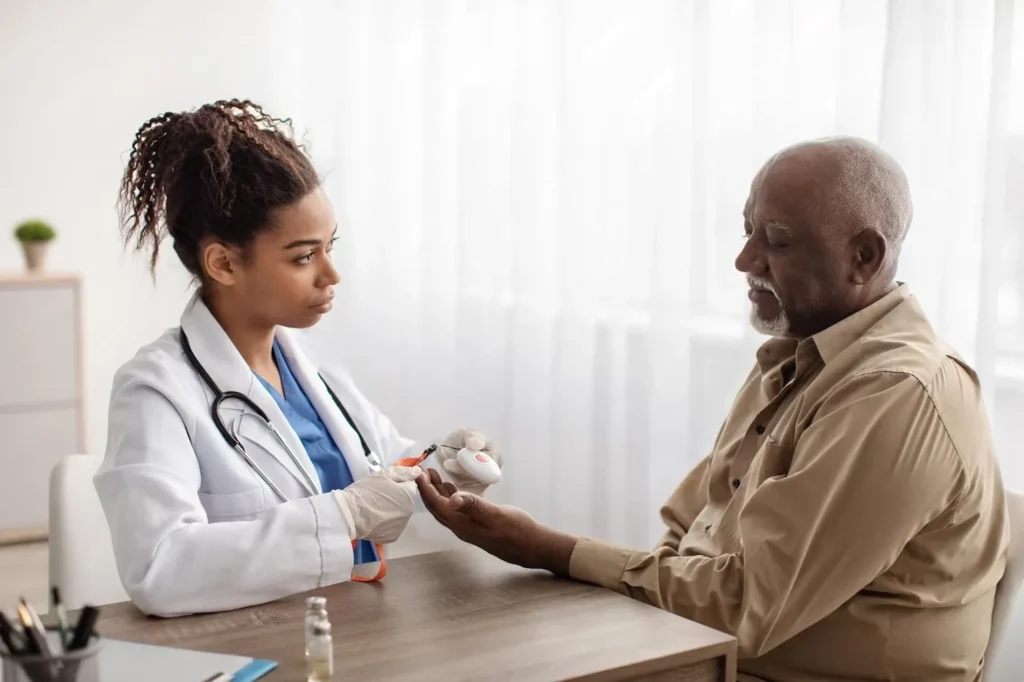 Abundance Health Care provider performing a blood glucose test on a senior patient in Colorado Springs, CO