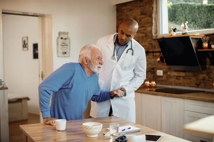Abundance Health Care doctor assisting a senior patient during an in-home visit in Colorado Springs, CO