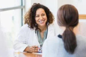 A provider consults with a patient at a family medicine clinic that specializes in women's health at Abundance Health Care