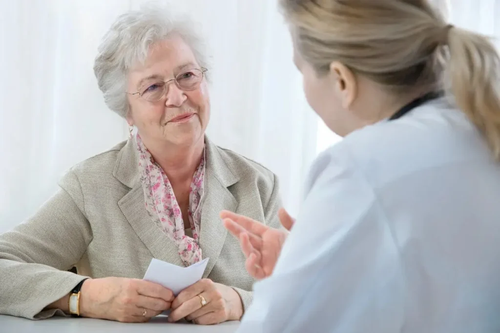 An older adult patient discusses UTI symptoms with her provider at Abundance Health Care