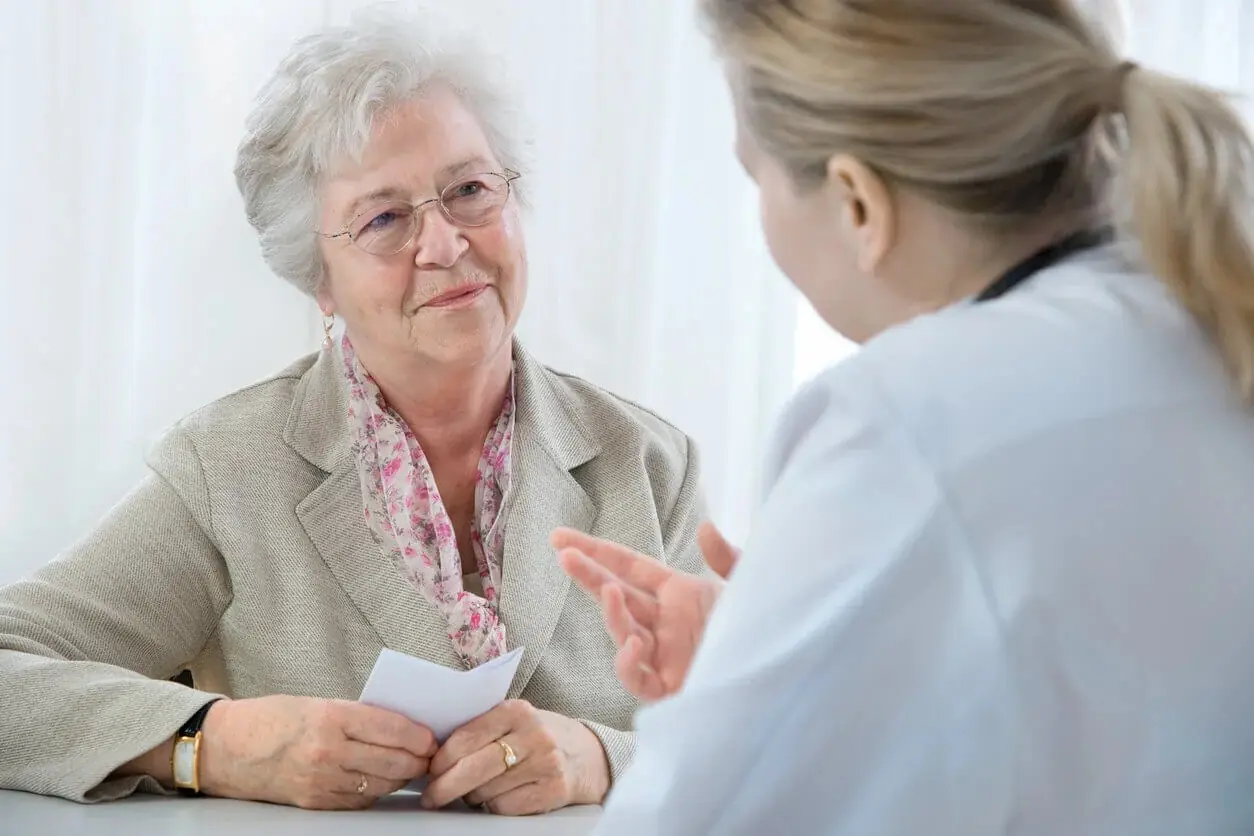An older adult patient discusses UTI symptoms with her provider at Abundance Health Care