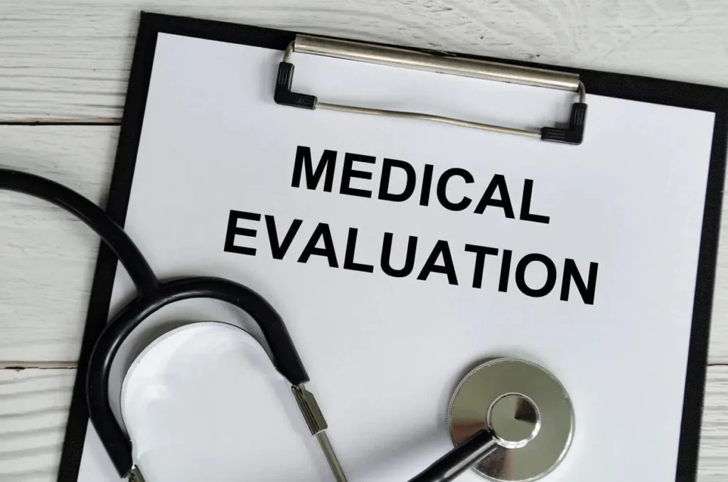 Medical evaluation notes written on a white paper clipboard accompanied by a stethoscope on a wooden table