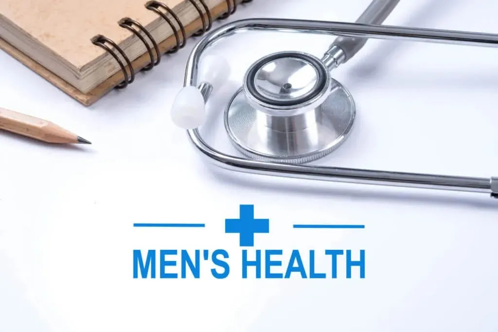 A stethoscope, notebook, and pencil beside a "Men's Health" sign representing a men's health checkup