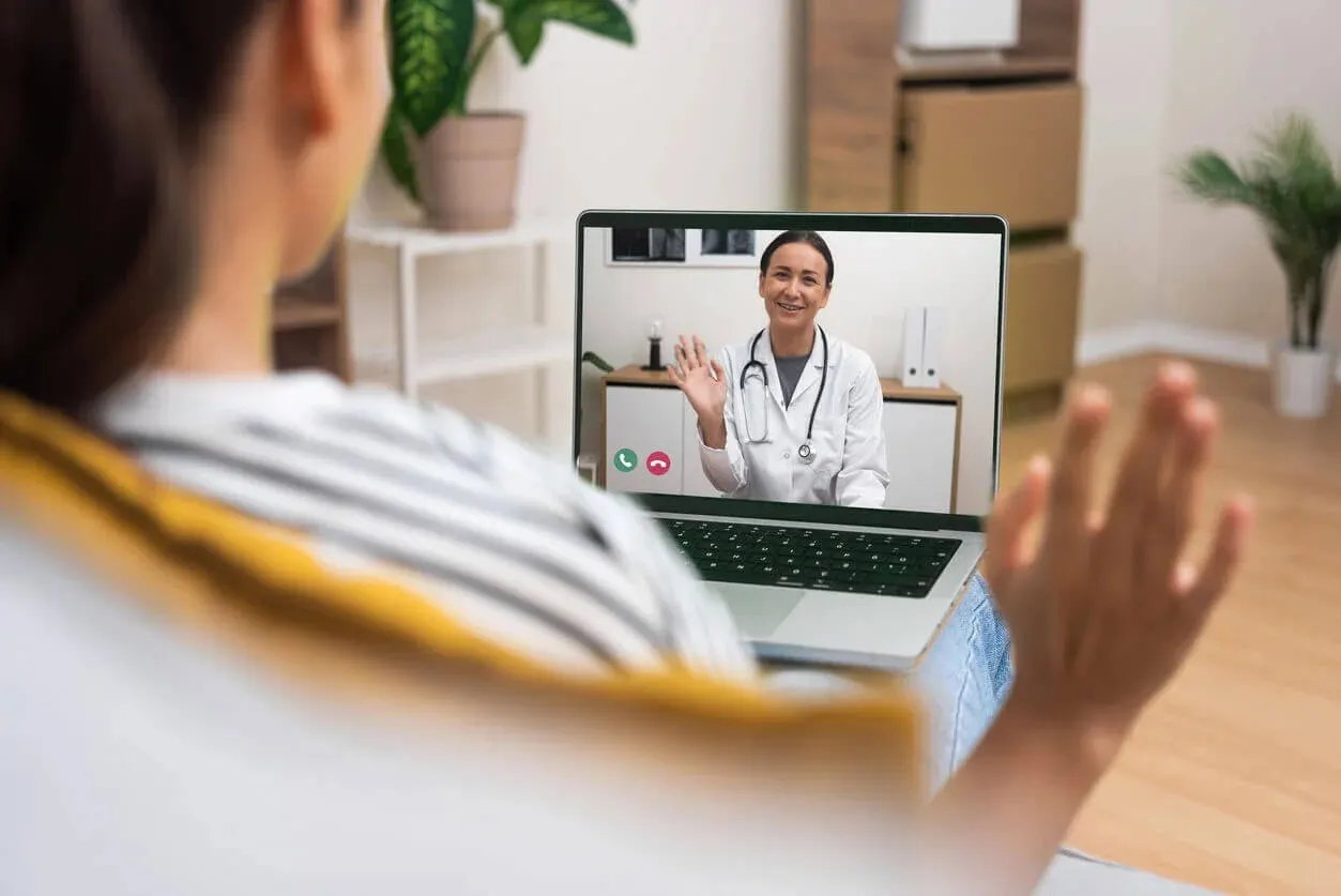 A patient has a friendly telehealth video call with her Abundance Health Care provider for primary care services
