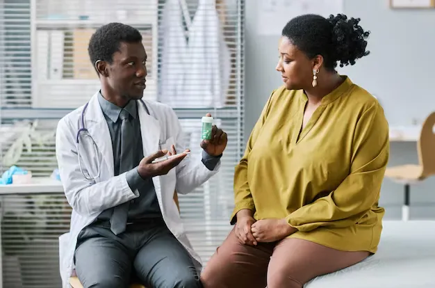 Doctor discussing a weight management plan with a patient during a clinic consultation