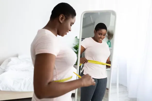 Woman tracking her health progress at home as part of a weight management plan