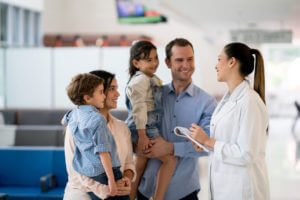 Family Doctor talking to a family at the hospital